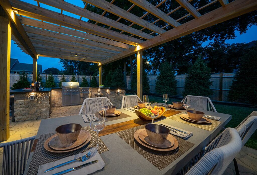 Outdoor living area at night with warm lighting