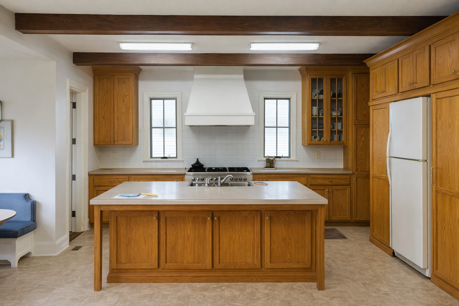 Full kitchen before remodel in Houston, Texas with original wood cabinets, laminate countertops, and outdated lighting – by Infinit Interiors