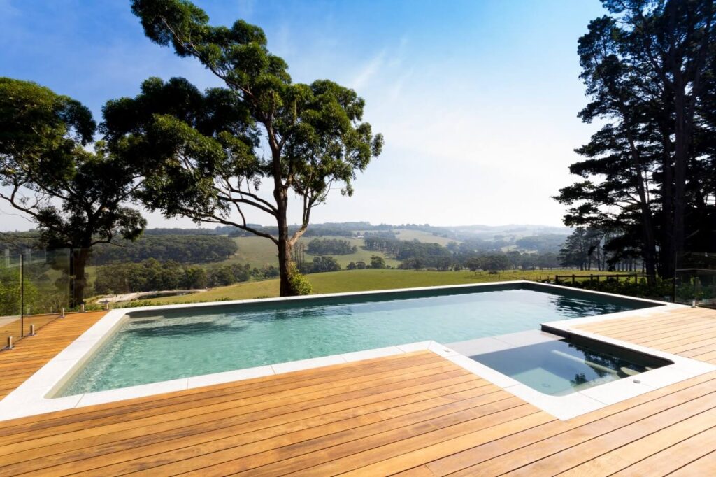 Residential outdoor swimming pool with wooden deck